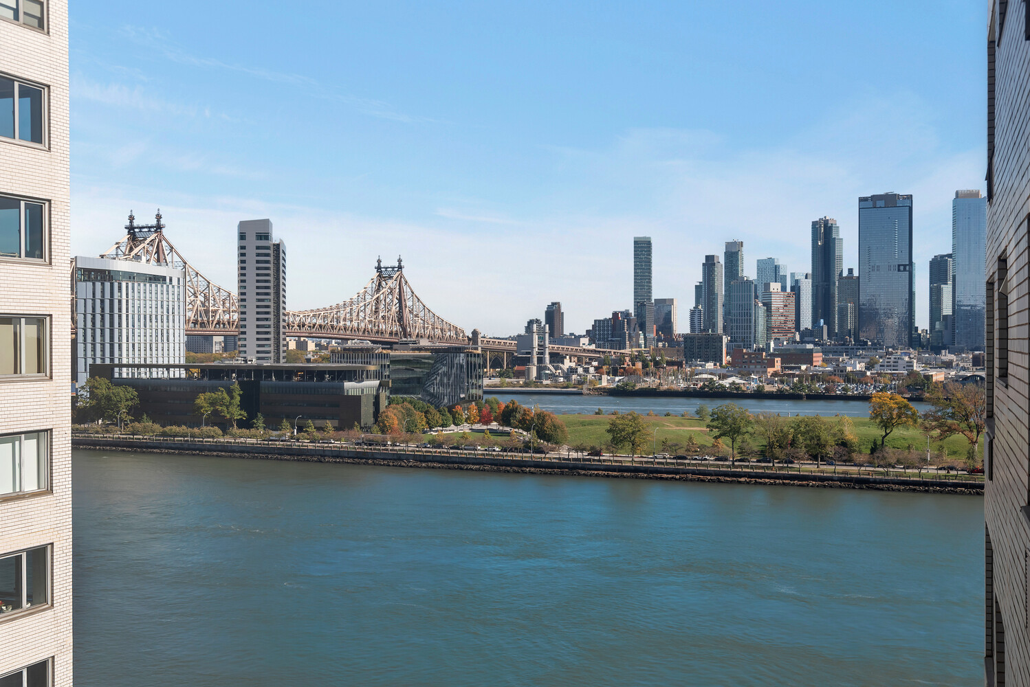 45 Sutton Place South, Unit 11J Manhattan, NY 10022 - Photo 2 of 19 a view of a city with tall buildings