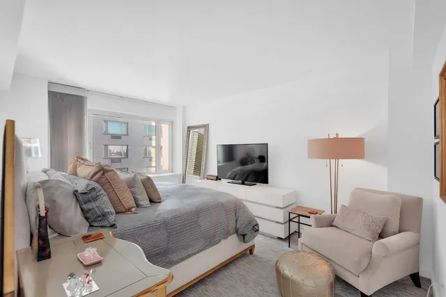 a view of a dining room and livingroom with furniture wooden floor and a rug