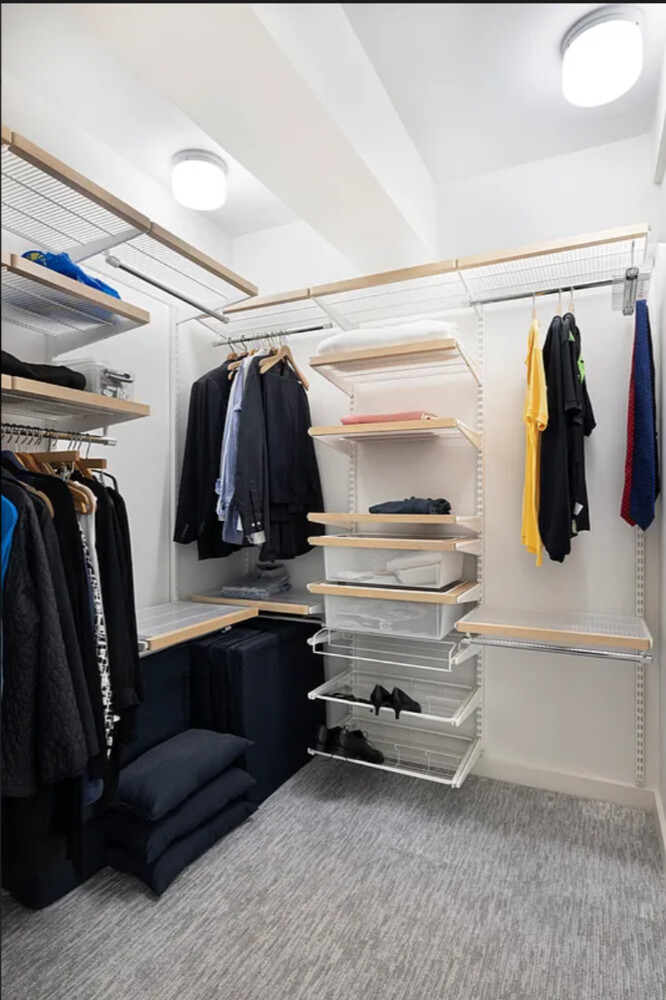 45 Sutton Place South, Unit 11J Manhattan, NY 10022 - Photo 6 of 19 a view of walk in closet with clothes and shoes