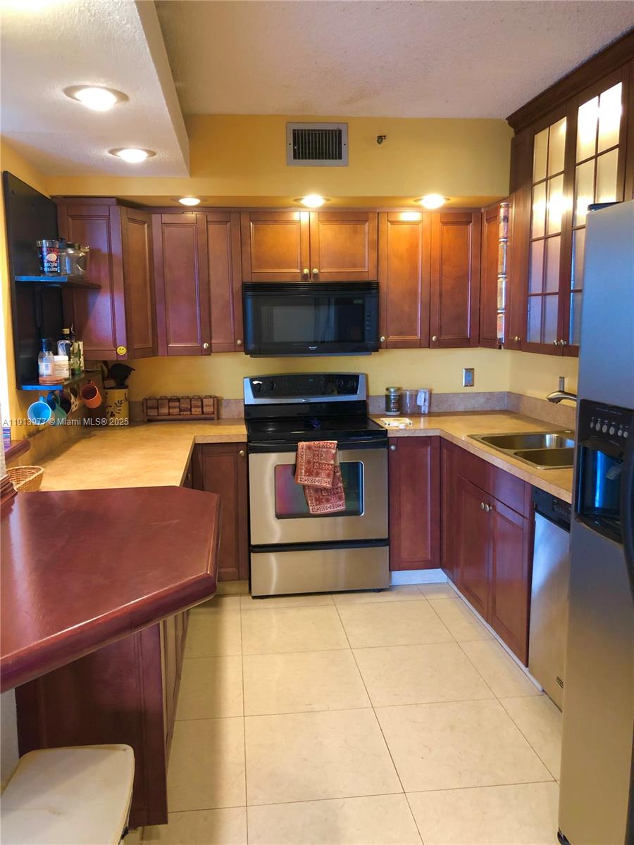 919 Hillcrest Drive, Unit 704 Hollywood, FL 33021 - Photo 22 of 43 a kitchen with a sink and cabinets