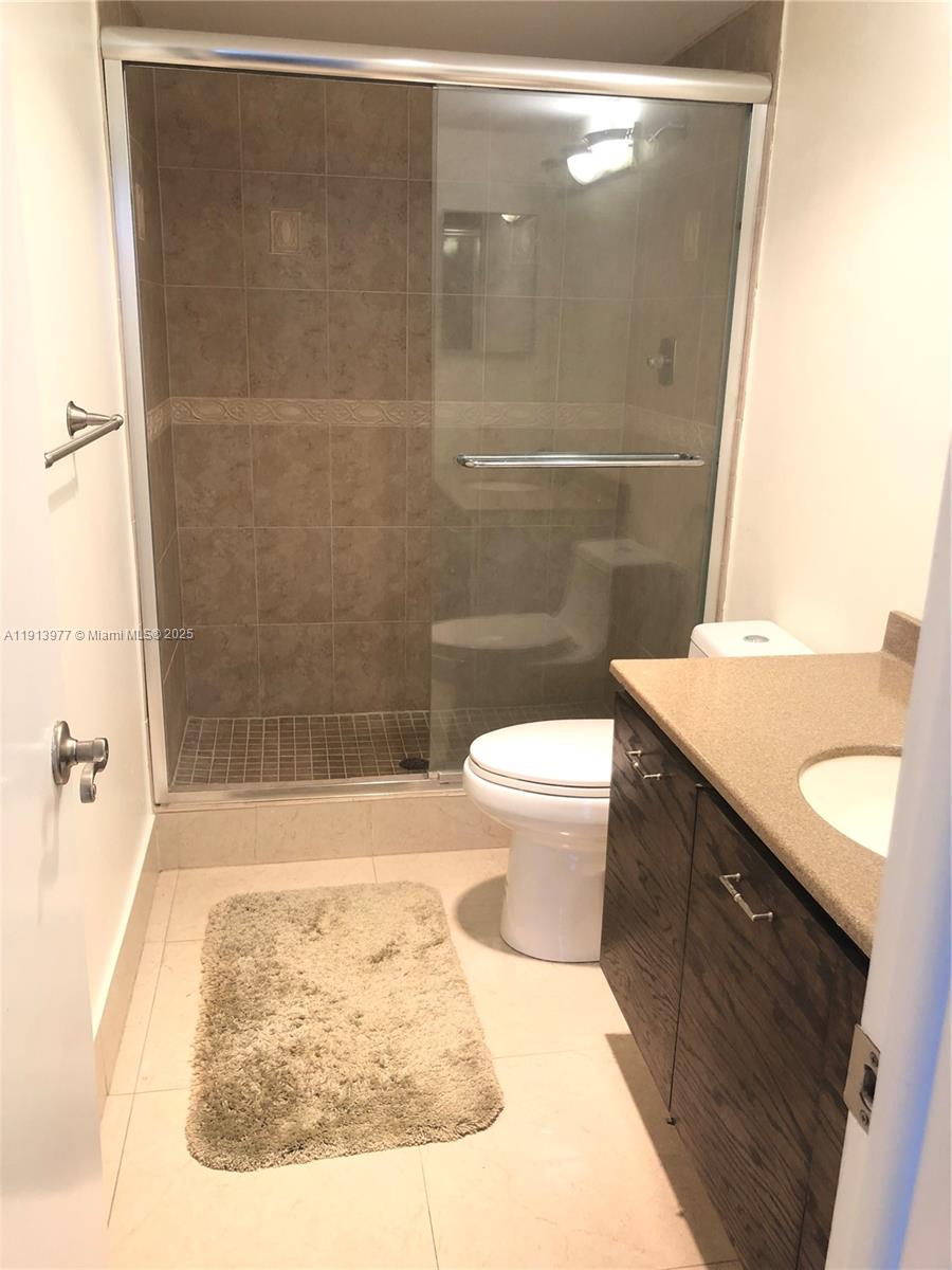 919 Hillcrest Drive, Unit 704 Hollywood, FL 33021 - Photo 31 of 43 a bathroom with a sink a toilet and shower
