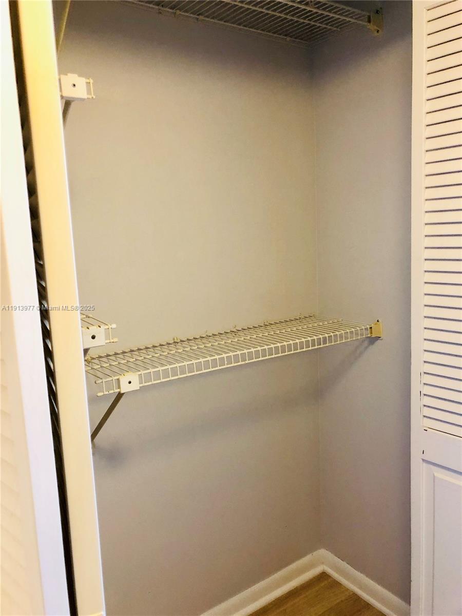 919 Hillcrest Drive, Unit 704 Hollywood, FL 33021 - Photo 37 of 43 a bathroom with a glass shower door