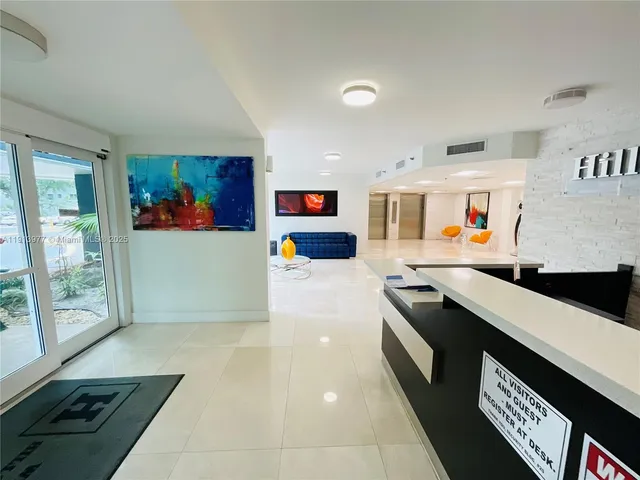 a kitchen with stainless steel appliances granite countertop a refrigerator and a stove