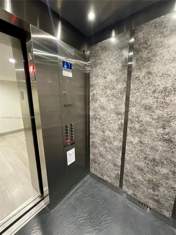 a lobby with furniture and a flat screen tv