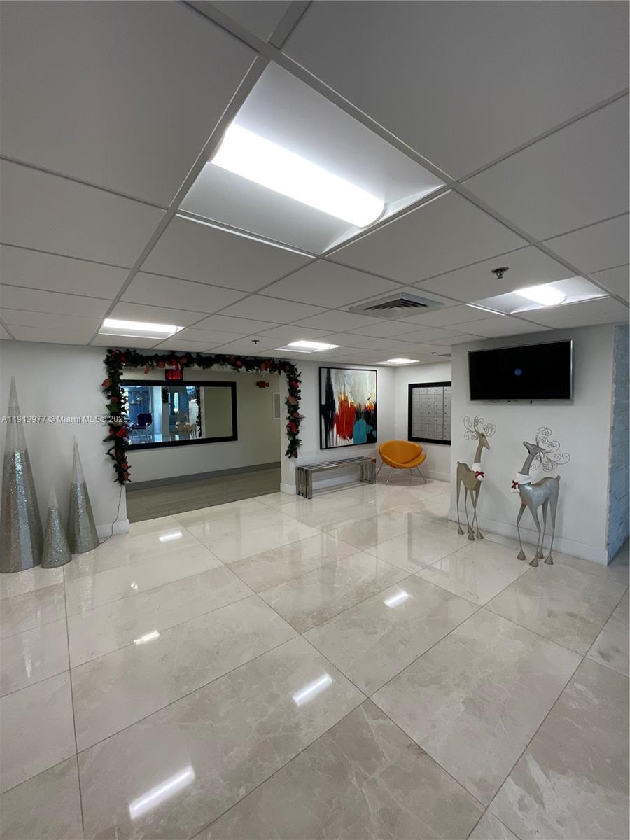 919 Hillcrest Drive, Unit 704 Hollywood, FL 33021 - Photo 43 of 43 a lobby with furniture and a flat screen tv