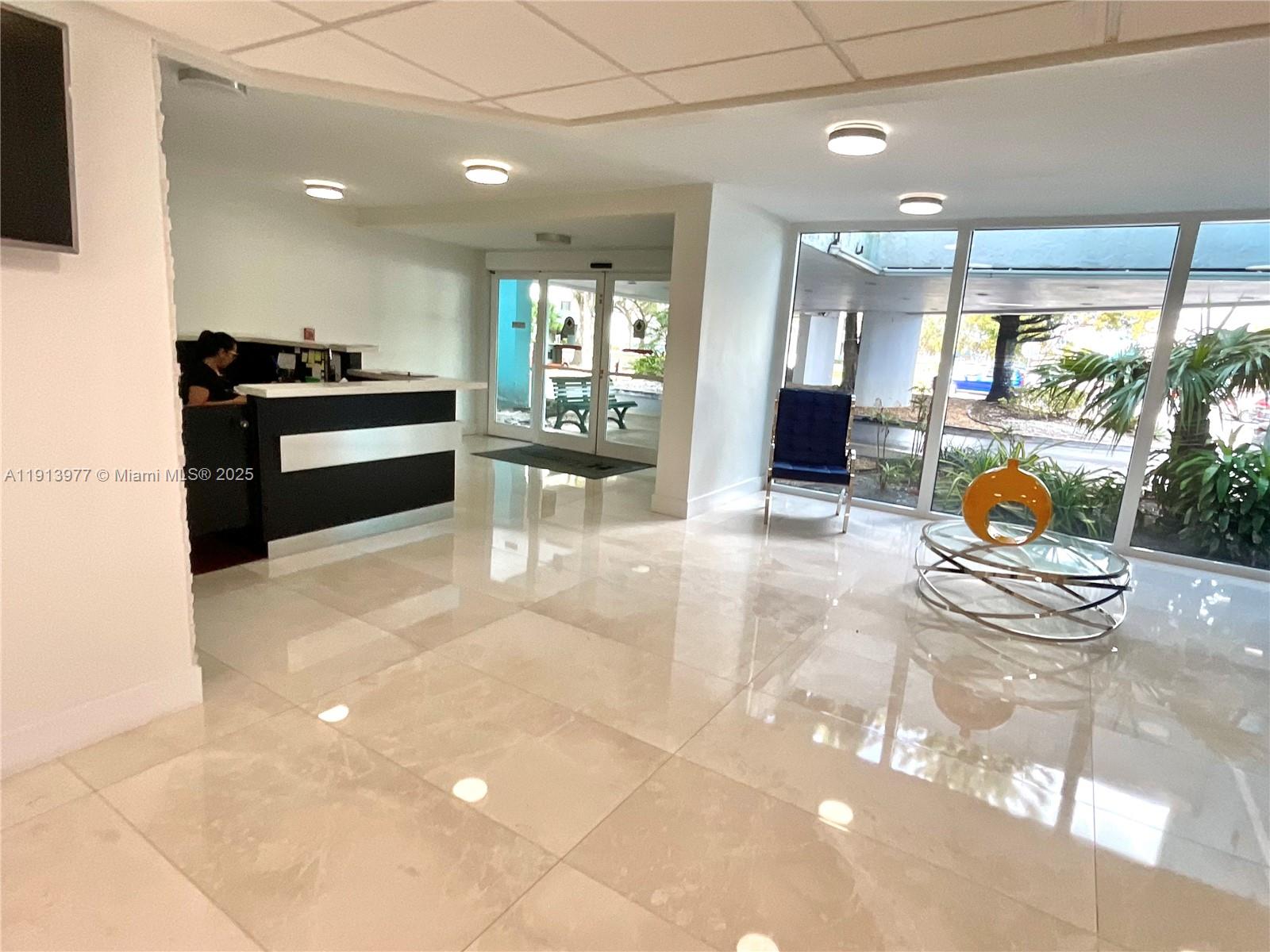 919 Hillcrest Drive, Unit 704 Hollywood, FL 33021 - Photo 9 of 43 a kitchen with stainless steel appliances dining table chairs and stove
