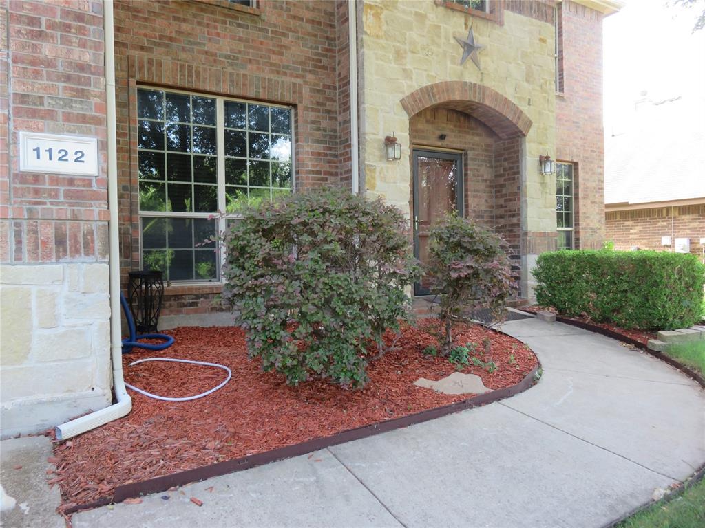 1122 Walter Stephenson Road Midlothian, TX 76065 - Photo 2 of 26 Brick and stone facade featuring a prominent arched entryway