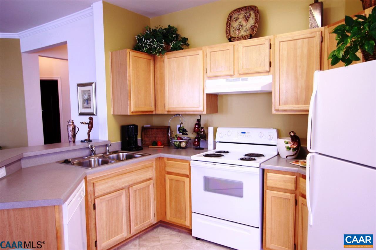 825 Beverley Drive, Unit C Charlottesville, VA 22911 - Photo 2 of 3 a kitchen with a stove a sink and a refrigerator