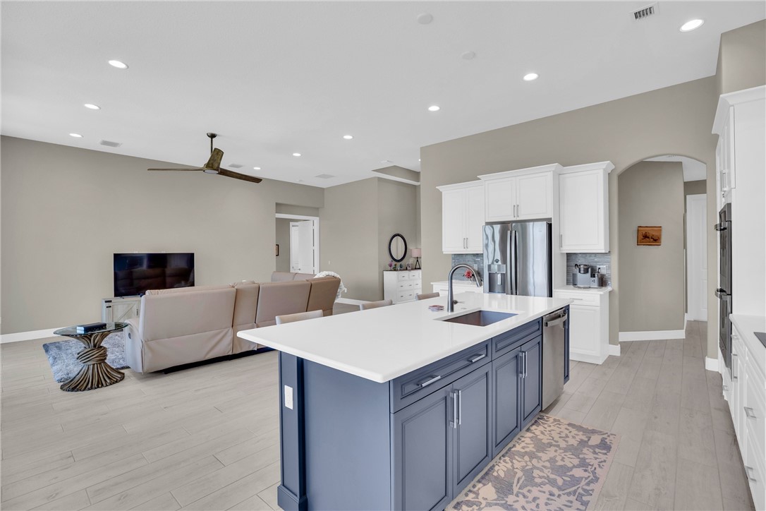 105 Night Hawk Way Sebastian, FL 32958 - Photo 8 of 36 a large living room with stainless steel appliances kitchen island granite countertop a couch and a view of living room