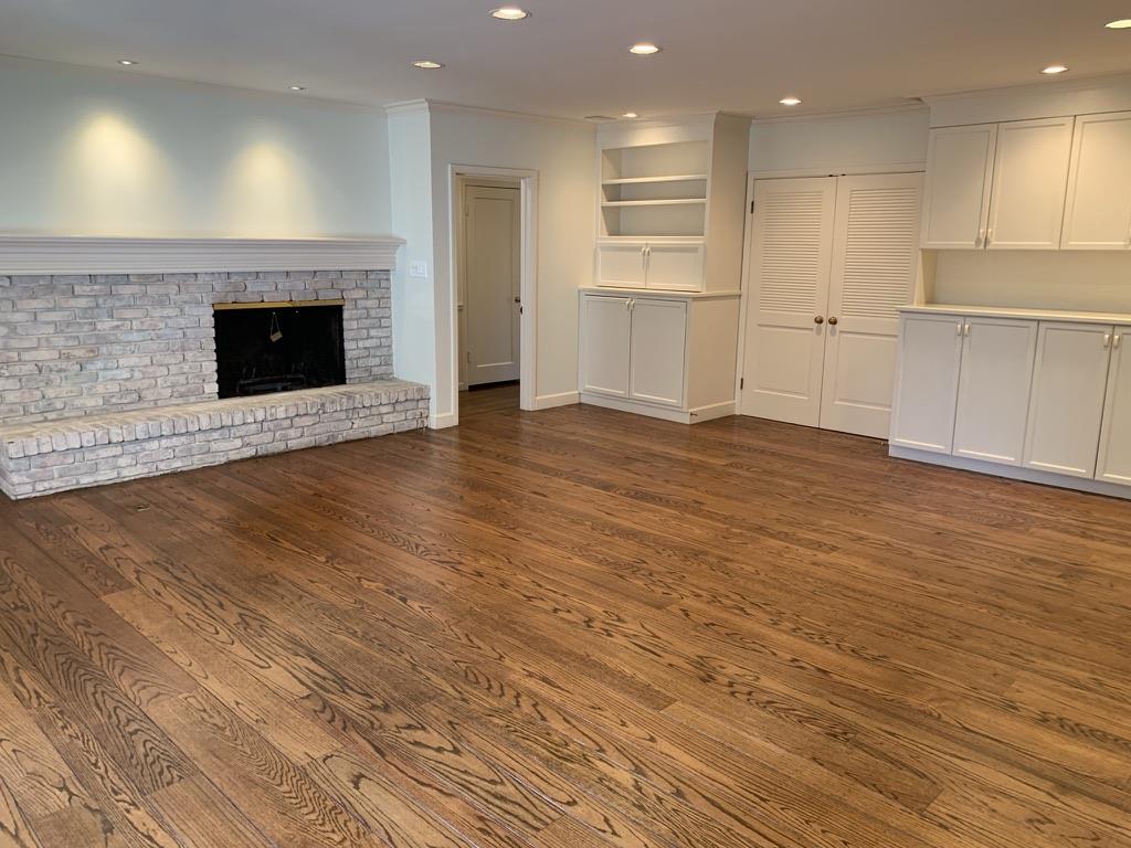 628 Alhambra Road San Mateo, CA 94402 - Photo 2 of 17 an empty room with wooden floor and fireplace
