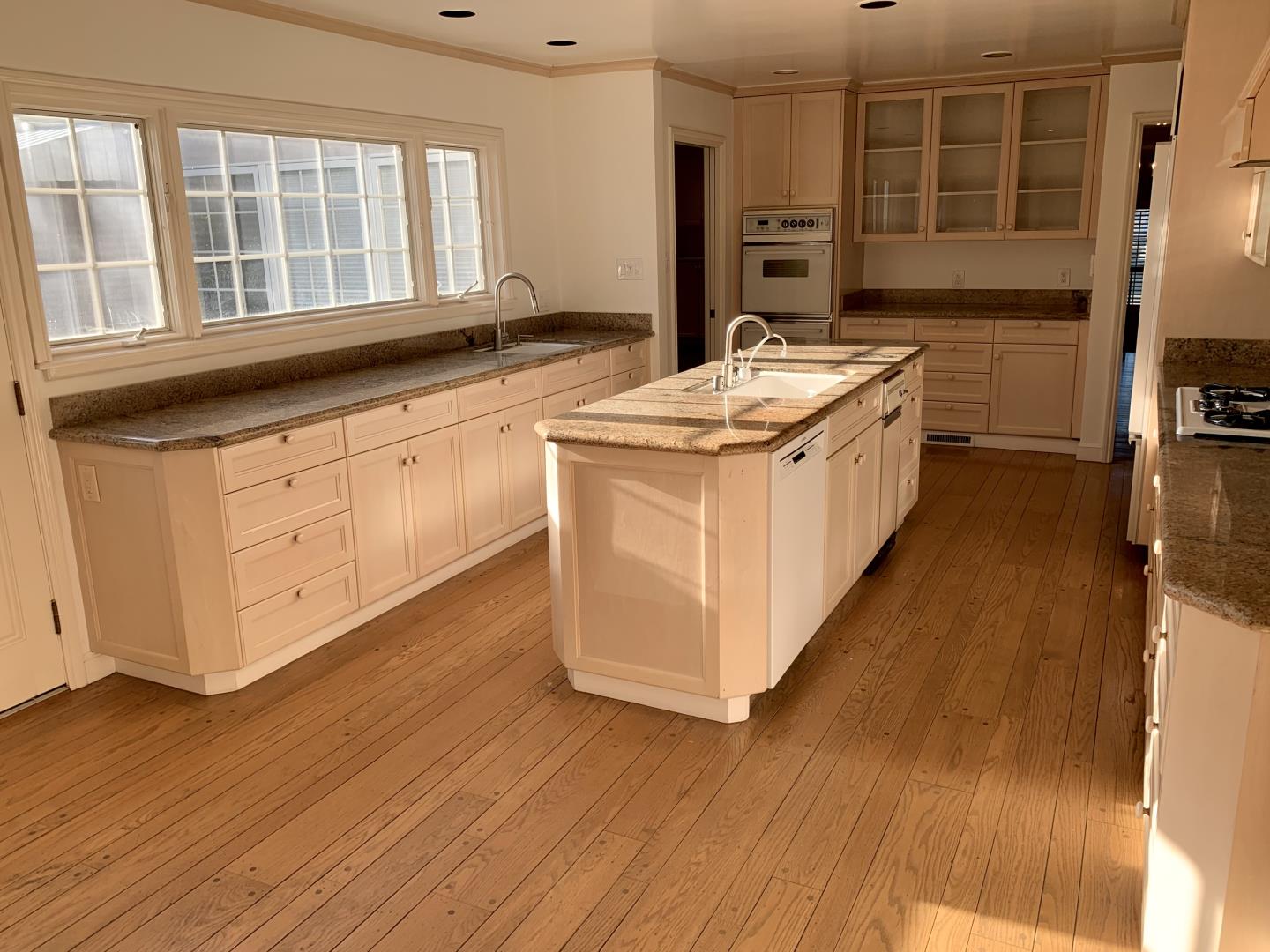 628 Alhambra Road San Mateo, CA 94402 - Photo 7 of 17 a kitchen with stainless steel appliances granite countertop a stove a sink and a refrigerator