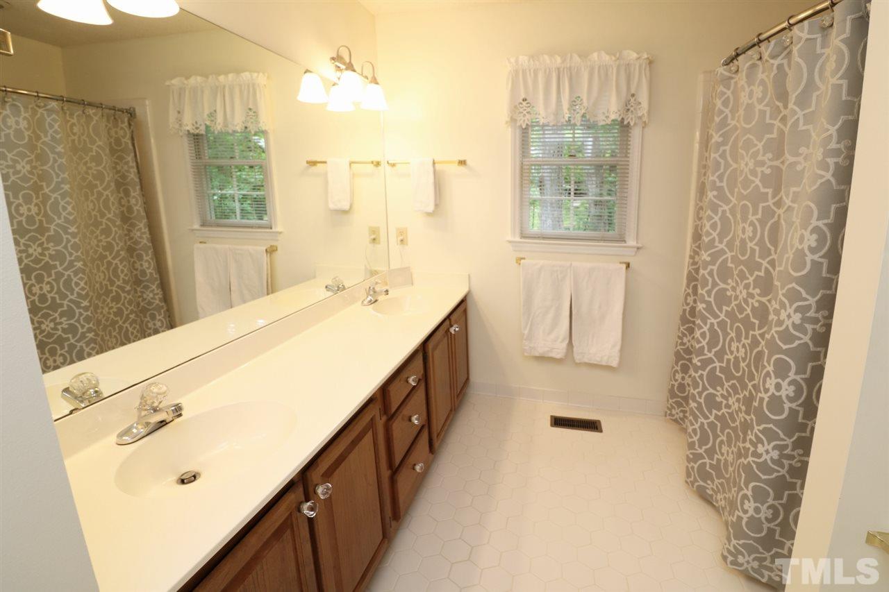 1500 Pecore Place Raleigh, NC 27615 - Photo 13 of 25 a bathroom with a sink and a shower