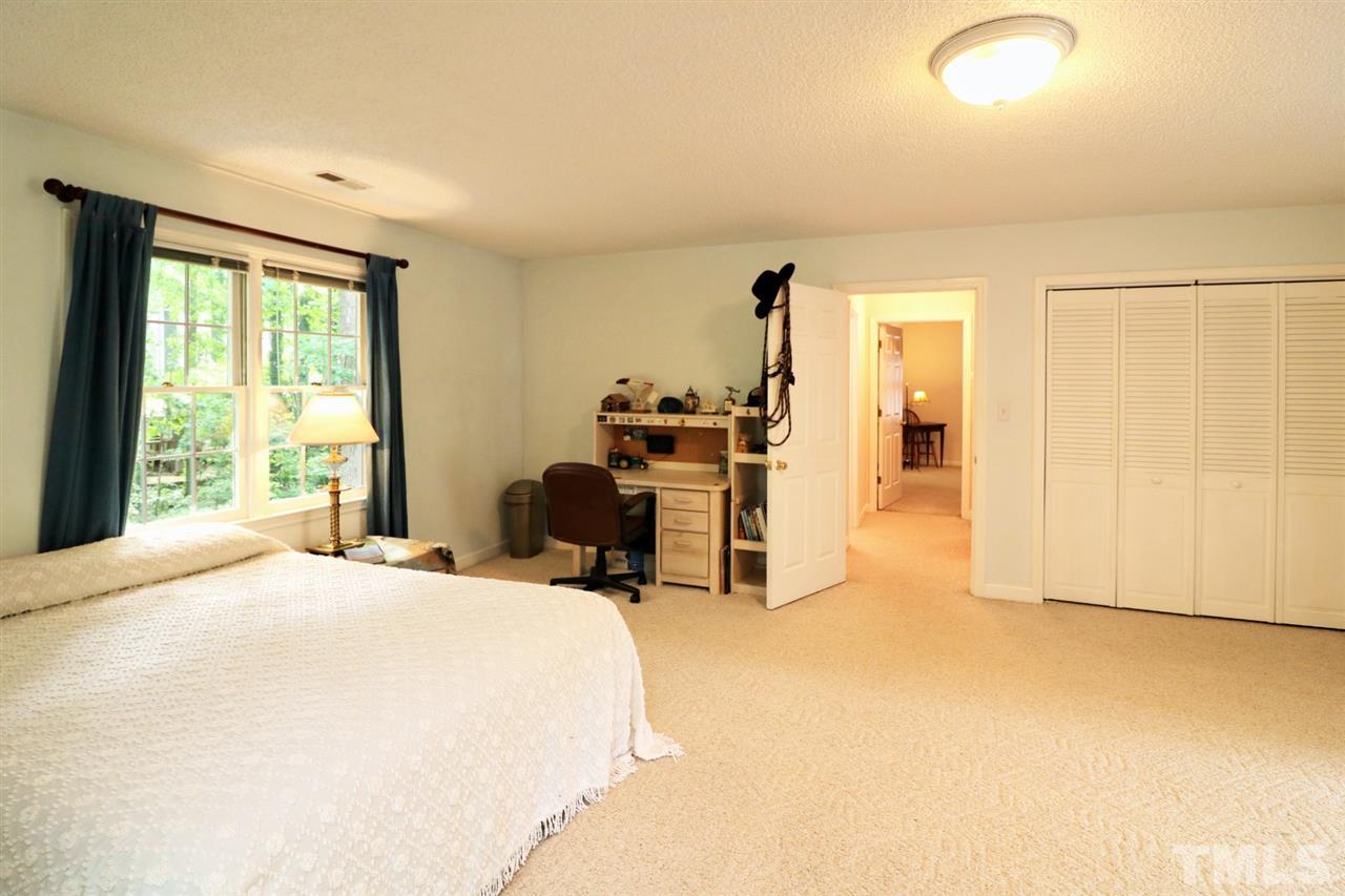 1500 Pecore Place Raleigh, NC 27615 - Photo 15 of 25 a bedroom with a bed and furniture