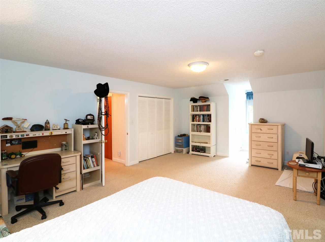 1500 Pecore Place Raleigh, NC 27615 - Photo 16 of 25 a bedroom with furniture and a desk