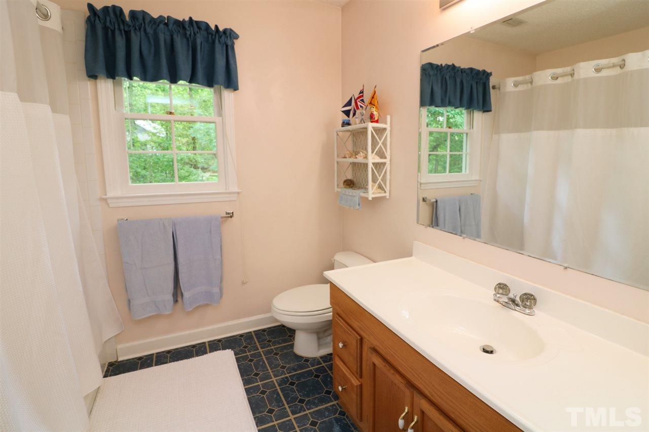1500 Pecore Place Raleigh, NC 27615 - Photo 17 of 25 a bathroom with a sink a toilet and a window