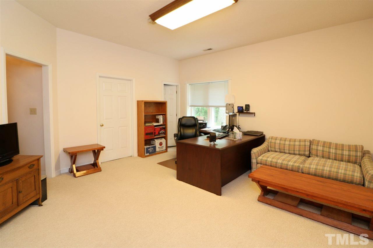 1500 Pecore Place Raleigh, NC 27615 - Photo 19 of 25 a living room with furniture and a flat screen tv