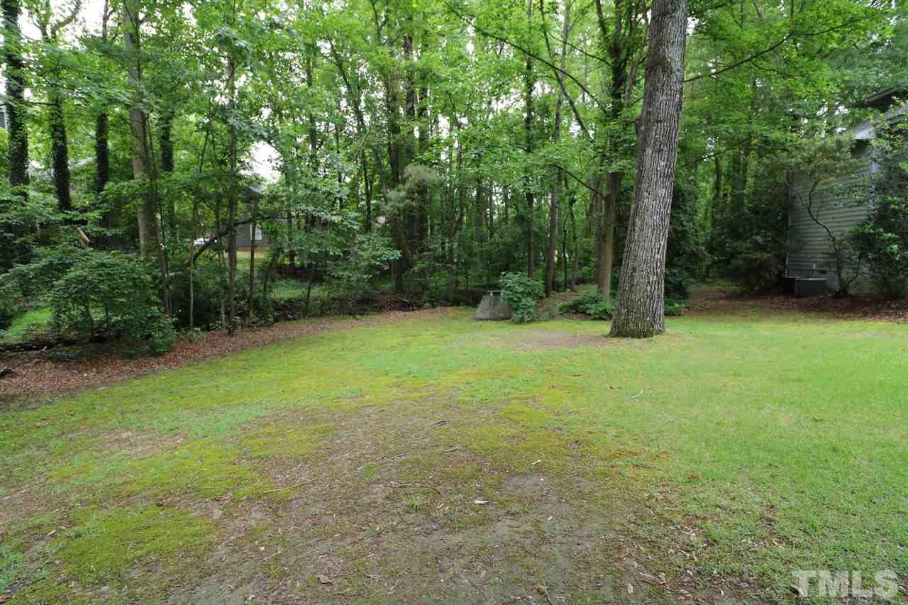 1500 Pecore Place Raleigh, NC 27615 - Photo 24 of 25 a view of a big yard with trees in the background