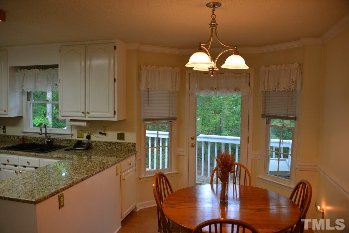 1500 Pecore Place Raleigh, NC 27615 - Photo 6 of 25 a view of a dining room with furniture window and wooden floor