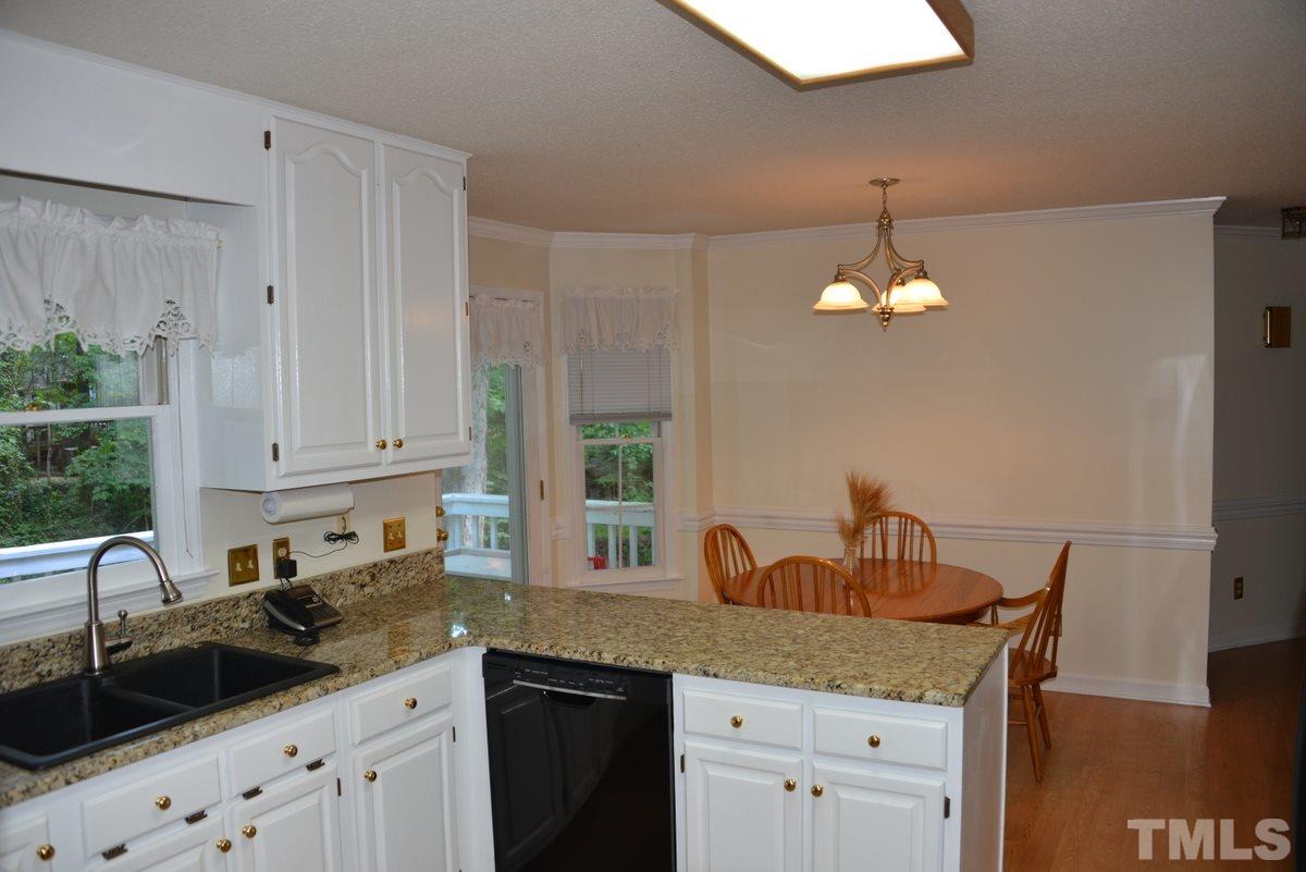 1500 Pecore Place Raleigh, NC 27615 - Photo 8 of 25 a kitchen with cabinets a sink and dishwasher