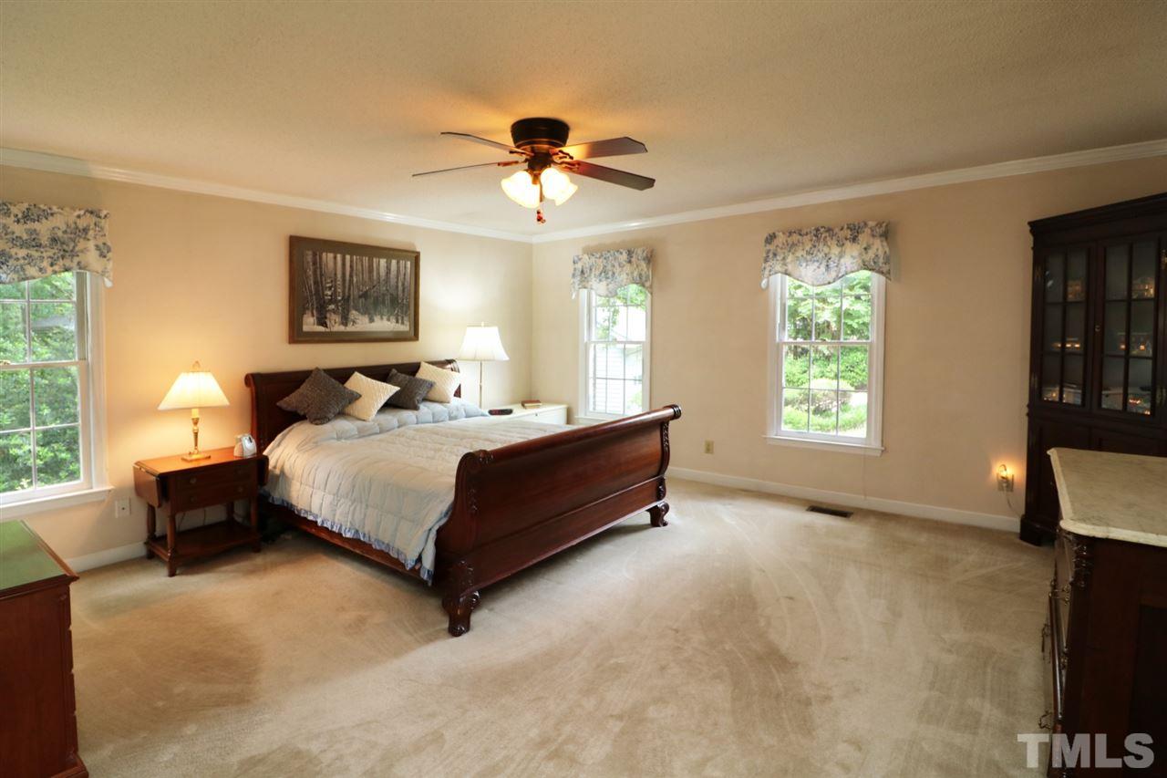 1500 Pecore Place Raleigh, NC 27615 - Photo 10 of 25 a bedroom with a bed painting on wall and a large window