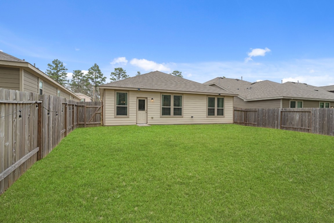 4041 Timber Sapp Drive Conroe, TX 77304 - Photo 13 of 14 a view of a house with a yard