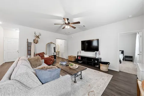 a living room with furniture and a flat screen tv