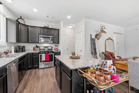 a kitchen that has a lot of cabinets and refrigerator