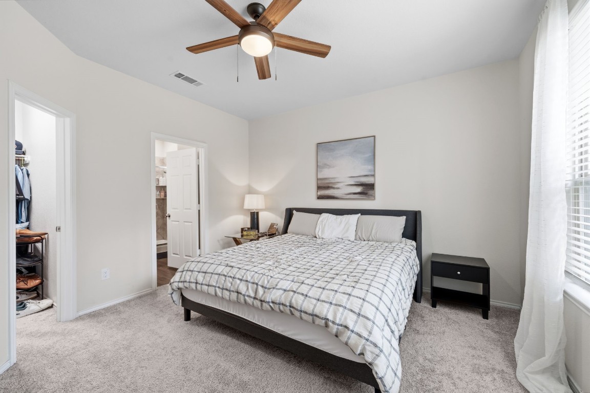 4041 Timber Sapp Drive Conroe, TX 77304 - Photo 7 of 14 a bedroom with a bed and a chandelier
