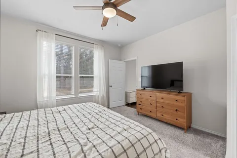 a bedroom with a bed and flat screen tv