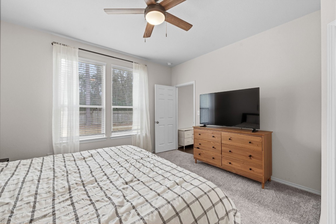 4041 Timber Sapp Drive Conroe, TX 77304 - Photo 8 of 14 a bedroom with a bed and flat screen tv