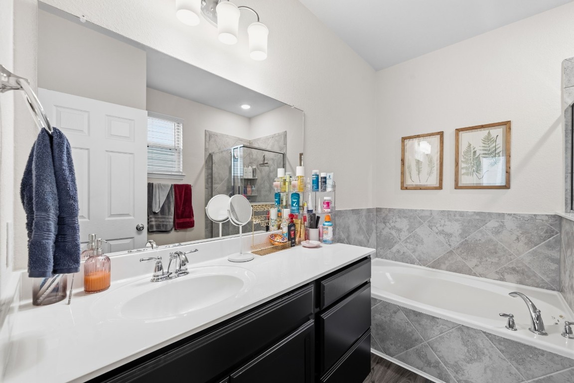 4041 Timber Sapp Drive Conroe, TX 77304 - Photo 9 of 14 a bathroom with a tub sink double vanity granite and a mirror