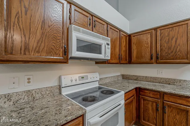 a kitchen with a sink a stove and cabinets