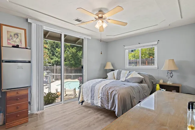 a bedroom with a bed and a chandelier