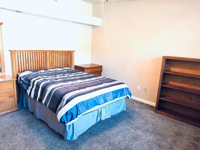 a bedroom with a bed and window