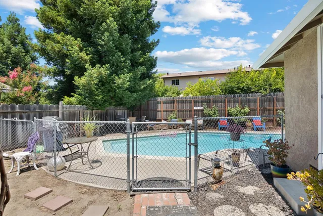 a view of a swimming pool with outdoor seating