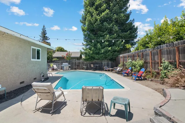a view of a backyard with sitting area and furniture