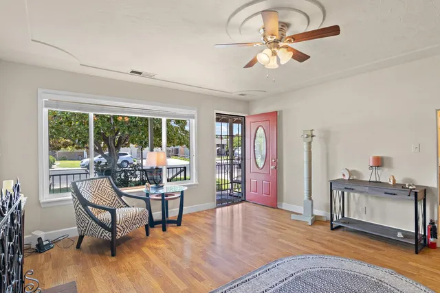 a living room with furniture and a floor to ceiling window