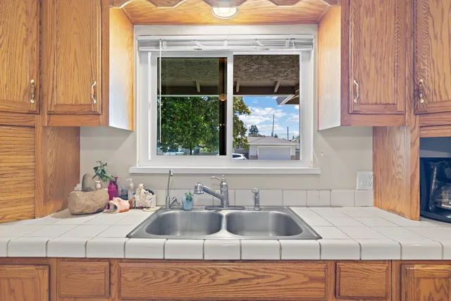 a dining room with furniture a chandelier and wooden floor