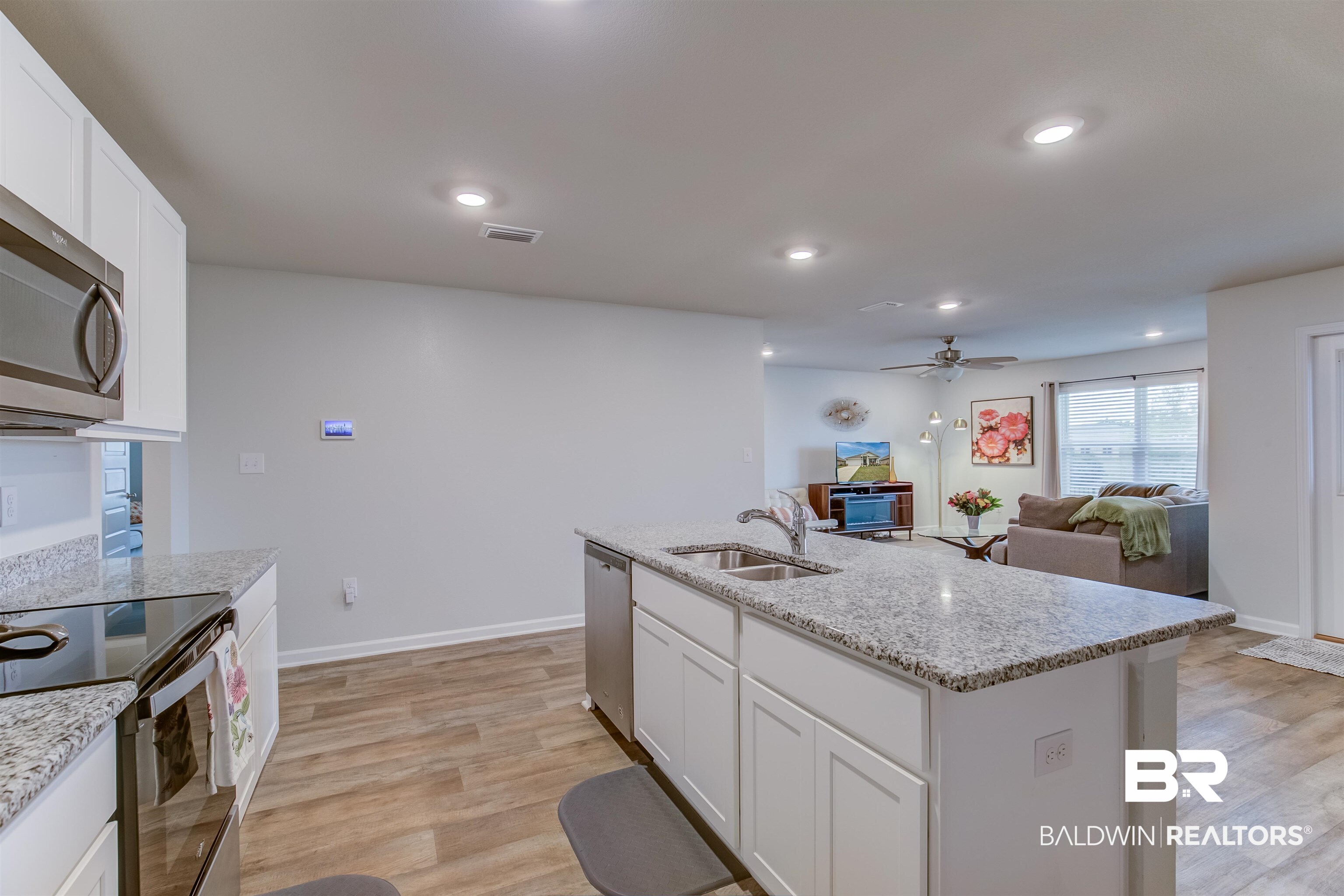 8033 Irwin Loop Daphne, AL 36526 - Photo 19 of 38 Contemporary kitchen island with granite countertops and an undermount sink