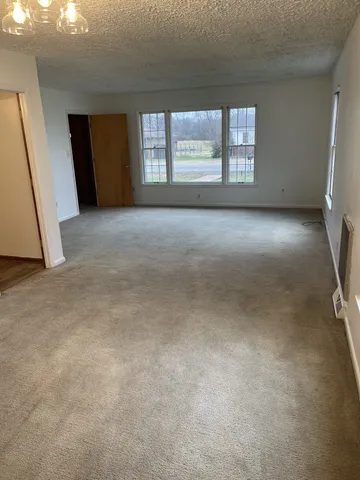 an empty room with wooden door