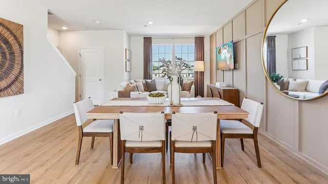 a dining room with furniture and wooden floor