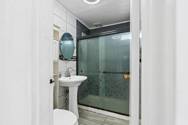 a bathroom with a sink mirror and toilet