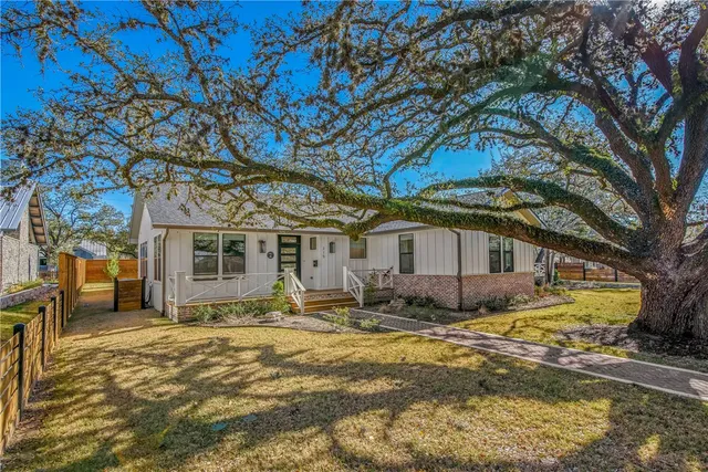 a large tree in front of a house