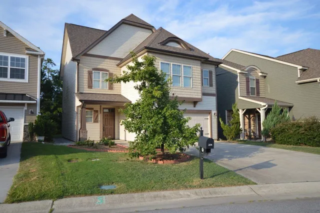 a front view of a house with a garden