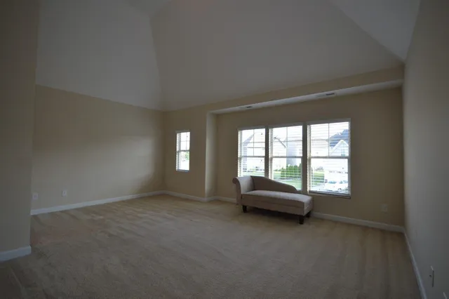 a living room with a window and a couch