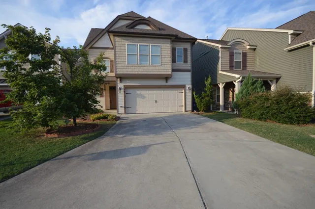 a front view of a house with a garden