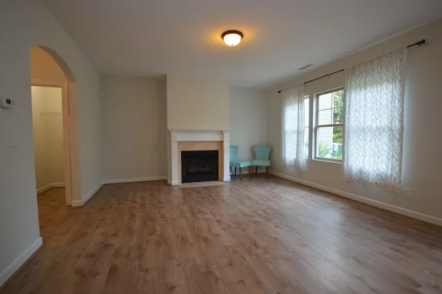 wooden floor fireplace and natural light in room