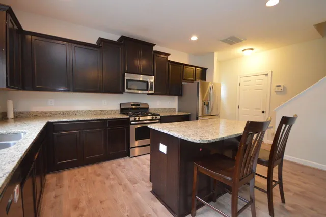 a kitchen with a stove a sink and a refrigerator