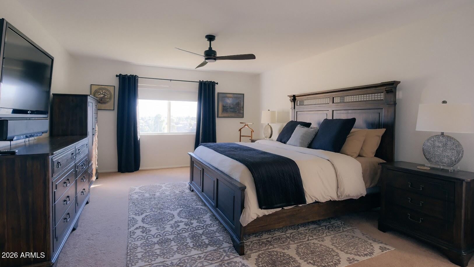 7940 East Camelback Road, Unit 608 Scottsdale, AZ 85251 - Photo 13 of 45 a bedroom with a bed and a flat tv screen on dresser