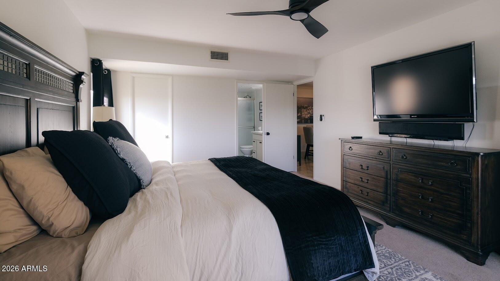 7940 East Camelback Road, Unit 608 Scottsdale, AZ 85251 - Photo 15 of 45 a bedroom with a bed and a flat tv screen on dresser